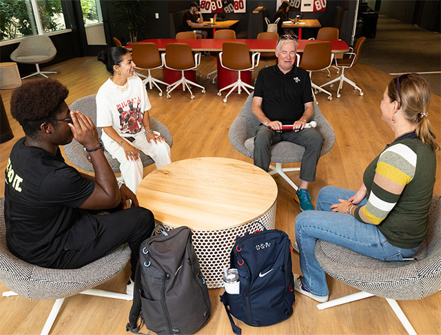 Employees talking in chairs at Nike world headquarters